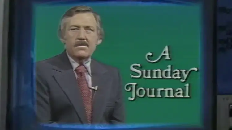 A mid 1970s WWL-TV studio television monitor, cropped so close that the borders of the device are slightly obscured. On the curved CRT monitor of the device, Jim Metcalf sits poised in the left half of the shot, in front of a verdant green screen, allowing room on the right side for the title of his popular television program 'A Sunday Journal' to float next to him in a closely spaced font with exaggerated serifs. Jim has a similarly well-groomed, serious but kind-eyed demeanor. He is visible from the waist up, in a charcoal colored suit, again with the wide lapels of the era, and a broad, burgundy tie with white spots against a pewter blue shirt.